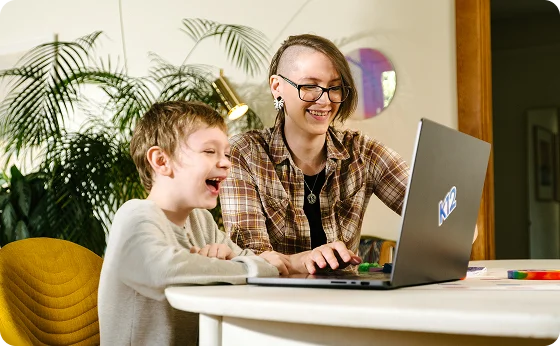 Mother and her son working together with their computer